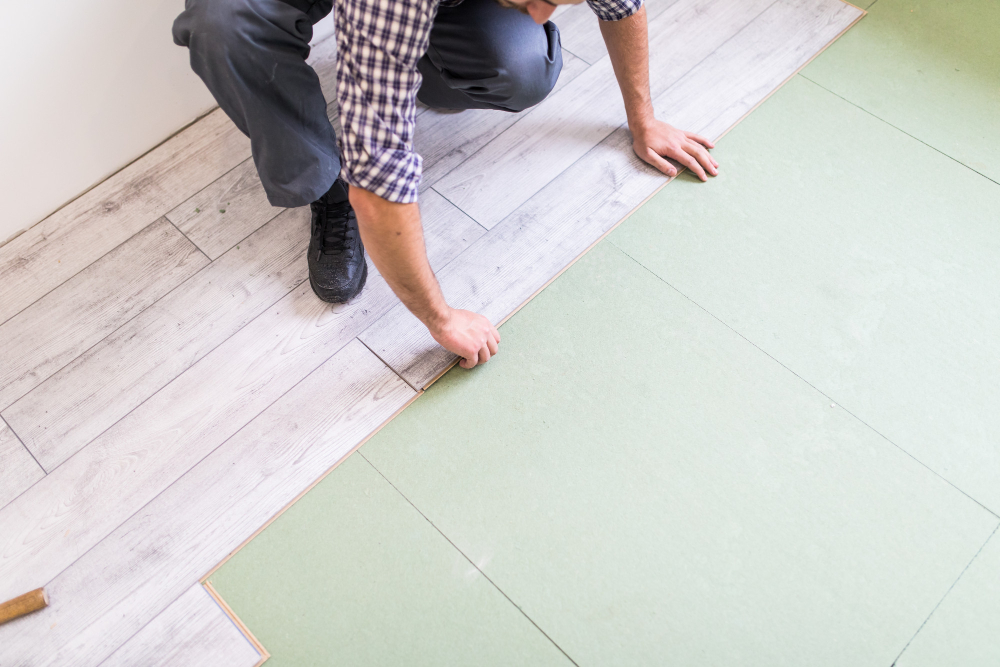 man installing new flooring