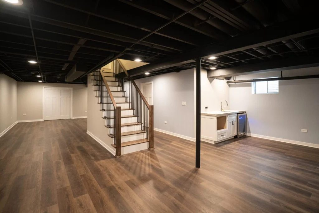 a basement with a staircase and a wood floor