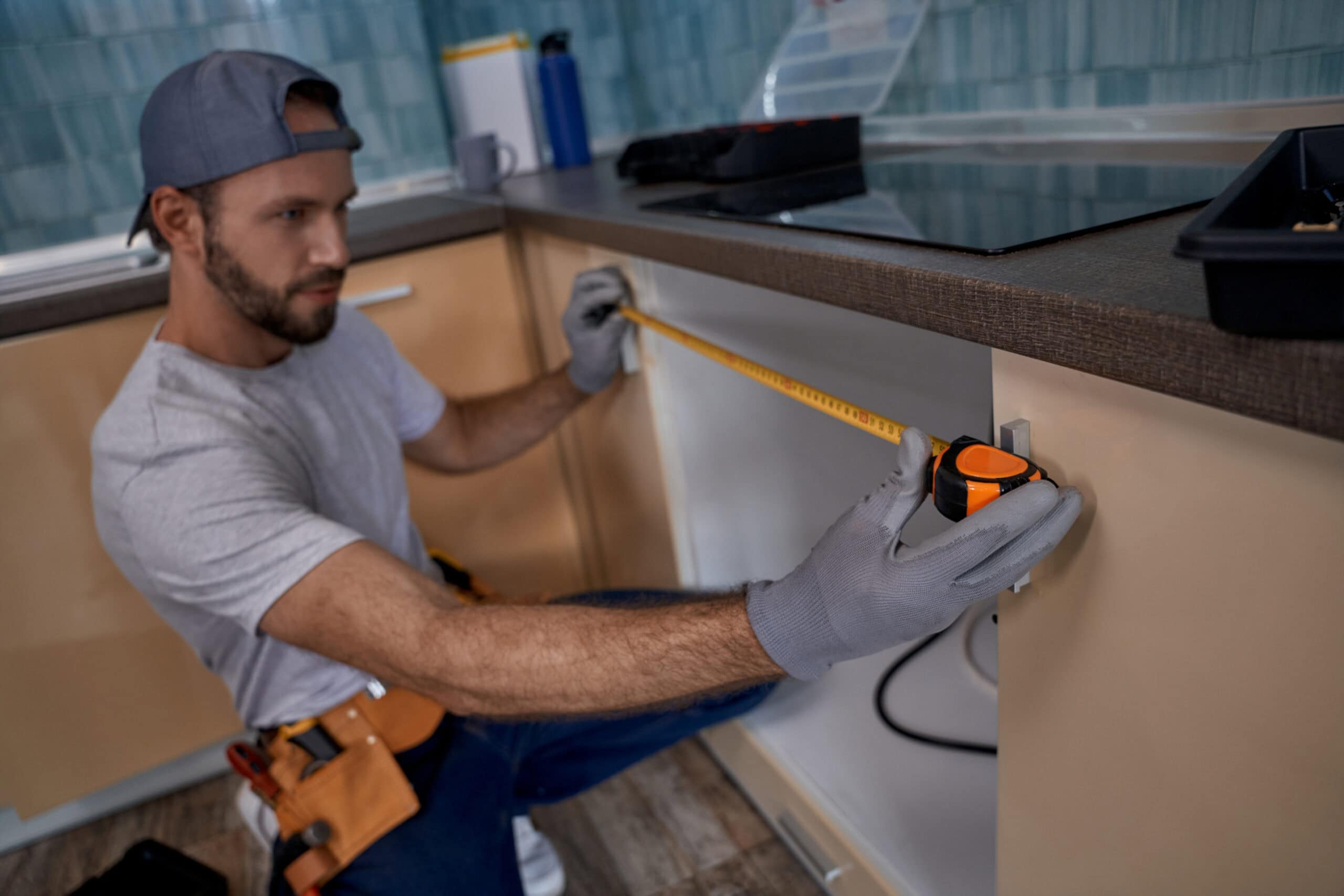 kitchen remodeler holding measuring tape