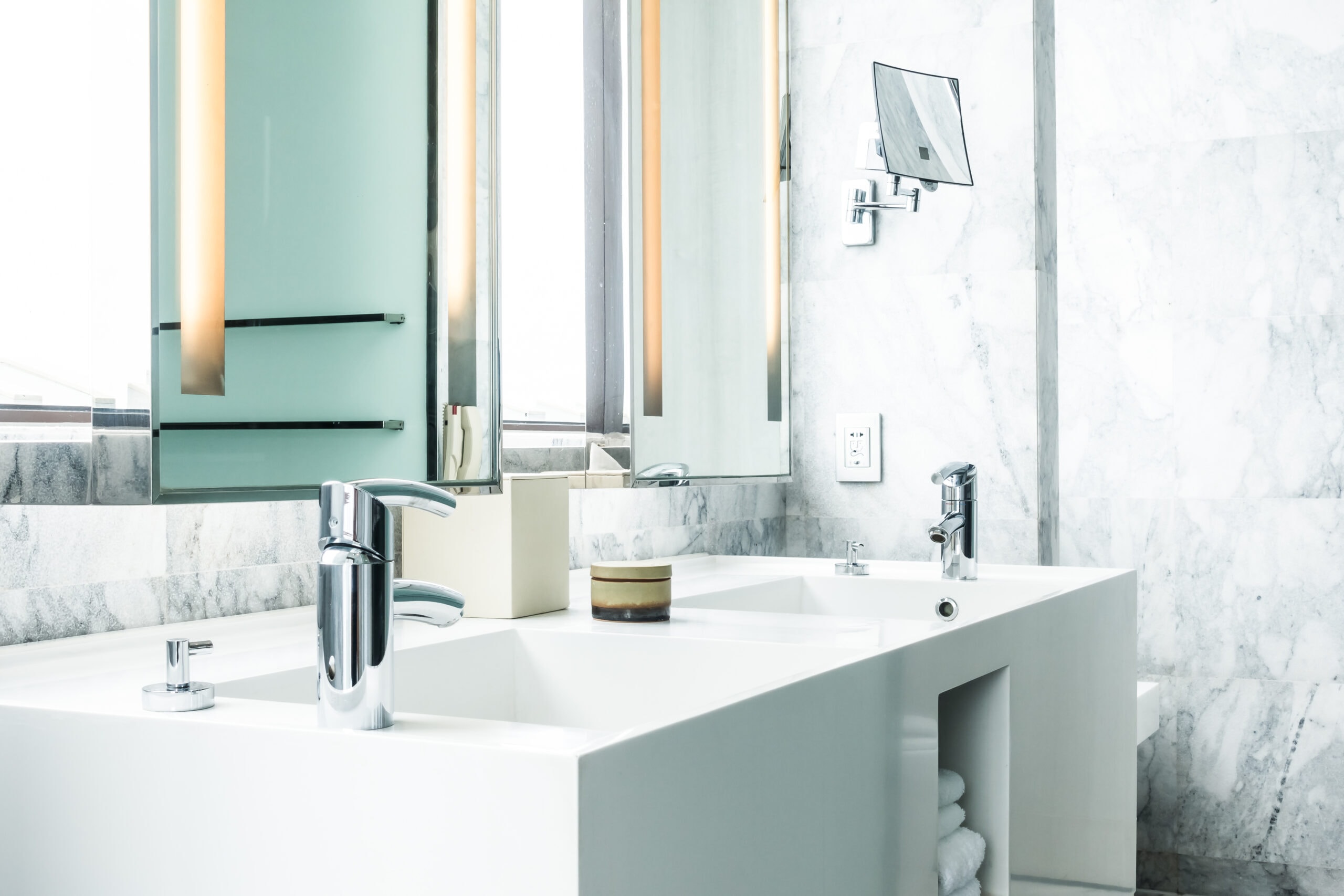 white porcelain sink with towels