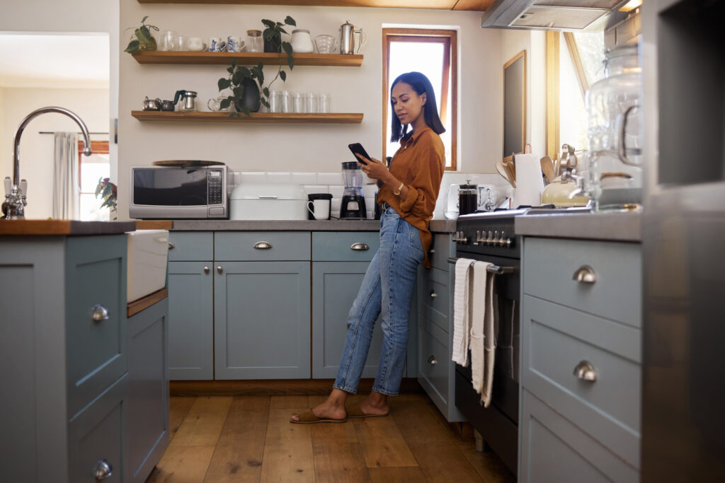 woman with a coffee cup standing in the kitchen